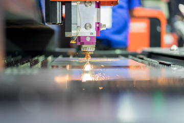 High precision CNC laser cutting metal sheet with bright sparkle in factory