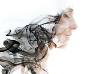 Double exposure photograph of a young woman combined with an image of the smoke