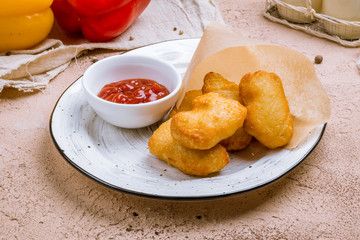 Fried chicken nuggets with ketchup