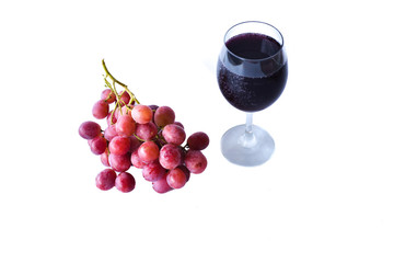 ripen red grapes and a glass of wine isolated on white background. selective focus.