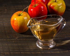 apple vinegar on a wooden rustic background