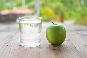 Green apple on wooden table. selective focus.