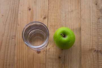 Green apple on wooden table. selective focus.