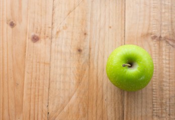 Green apple on wooden table. selective focus.