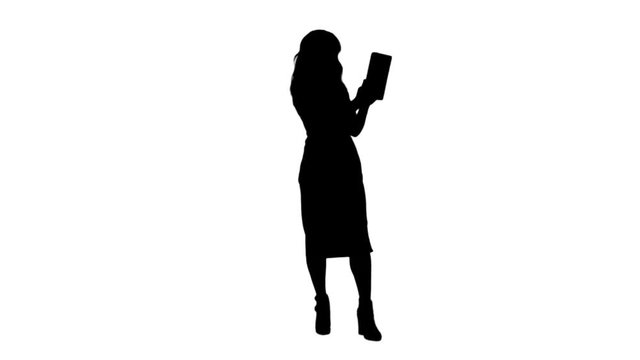 Silhouette Asian lady having video chat using a tablet track matte