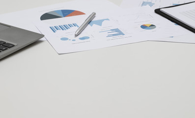 office desk with notebook and business chart