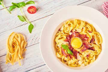 Carbonara pasta, spaghetti with pancetta, egg, hard parmesan cheese and cream sauce.