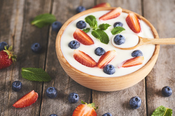 Homemade Greek yogurt or sour cream in a wooden bowl