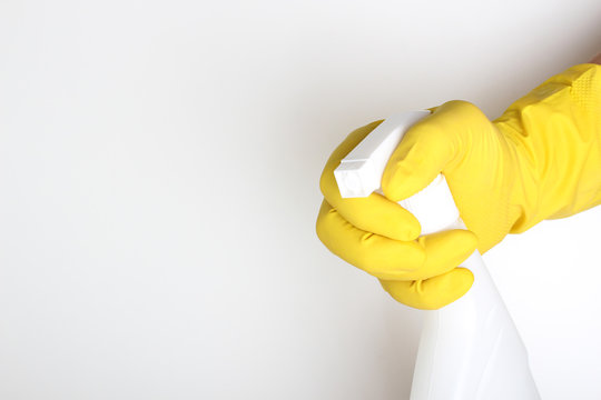 Hand Yellow Glove And White Bottle Sprayer