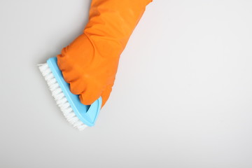 orange glove and blue brush