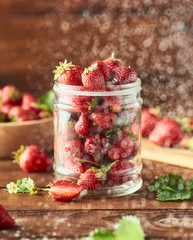 Fresh Healthy strawberry in glass jar over wooden background