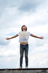 guy with open hands against the background of clouds