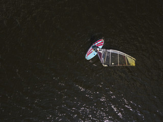 A drone shot aerial view of a surfer in the sea