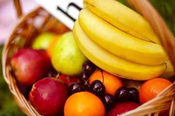 Basket with fruits on the lawn