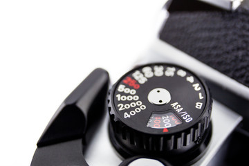 Shutter speed and ISO/ASA dial control of the 135 film Single Lens Reflect camera on white background, copy space on left hand side for edit or adding text.