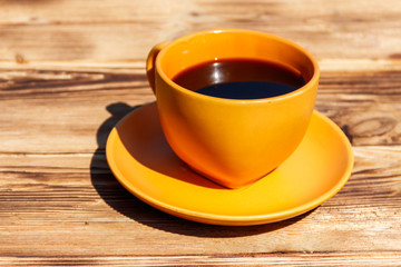 Cup of coffee on the wooden table