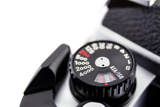 Shutter speed and ISO/ASA dial control of the 135 film Single Lens Reflect camera on white background, copy space on left hand side for edit or adding text.