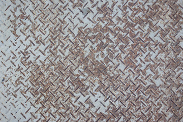 Rusty diamond metal board surface close up background.