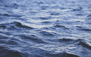 Splashing wave in sea on sunset