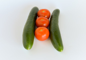 Tomatoes and cucumbers isolated on white background. selective focus.