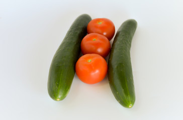 Tomatoes and cucumbers isolated on white background. selective focus.