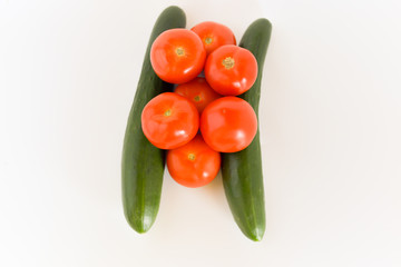 Tomatoes and cucumbers isolated on white background. selective focus.