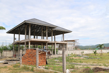 Closeup of a house is under construction and a pile of bricks.
