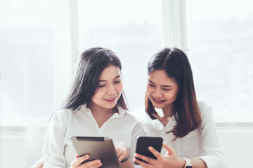 Woman using smartphone and tablet on the internet lifestyle. Concept of future and trend internet for easy access to information.