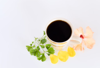 a cup of coffee with tropical flowers isolated on white background. selective focus.