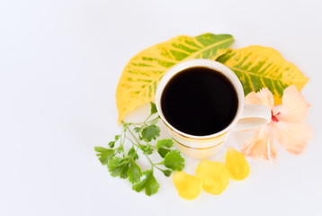 a cup of coffee with tropical flowers isolated on white background. selective focus.