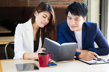 Asian couple aged between 25-30 years-old enjoy talking and drinking coffee together close up.