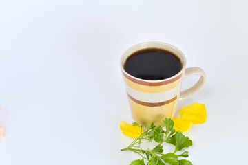 a cup of coffee with tropical flowers isolated on white background. selective focus.