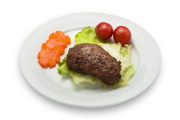 Cutlet with cherries, carrots and a lettuce, isolated on white background