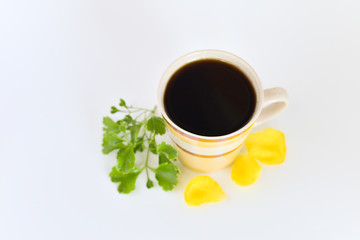 a cup of coffee with tropical flowers isolated on white background. selective focus.