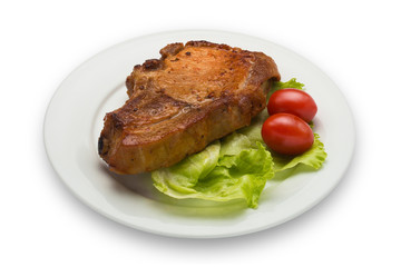 Steak with two cherries and a lettuce, isolated on white background