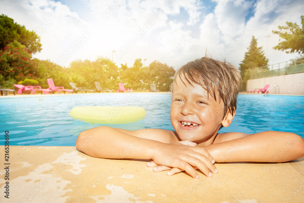 Sticker Happy boy relaxing at the swimming pool edge