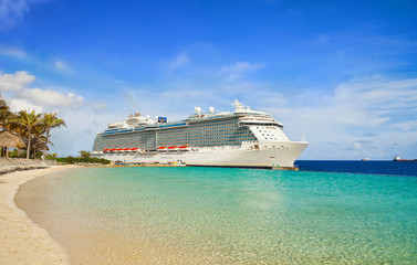 View from beach at tropical resort on cruise ship docked at port 