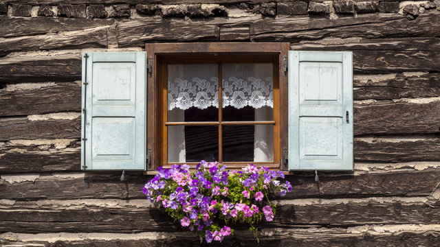 Traditional flowered windows at the Italian Alps and dolomites