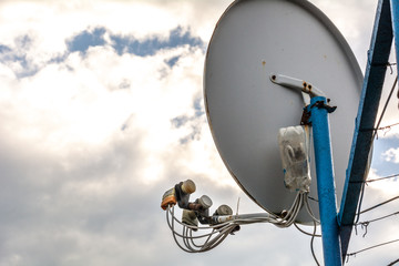 Satellite dish on the sky background