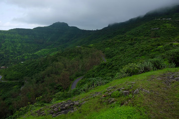 Fototapeta na wymiar Lush green monsoon nature landscape mountains, hills, Purandar, Pune, Maharashtra, India 