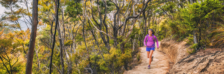 Ultra running race trail competition athlete woman runner on long distance marathon through forest and mountains in New Zealand, banner panorama.