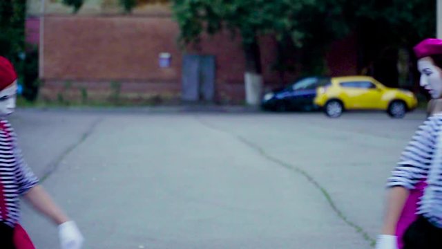Four funny mimes imitate car accident at the city