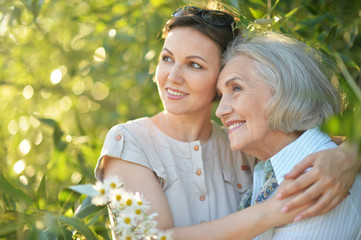 cheerful mother and adult daughter