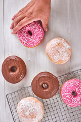 Donuts over rack and table glazing. Motion. Top view.
