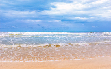 beautiful cleaning beach with cloudy blue sky