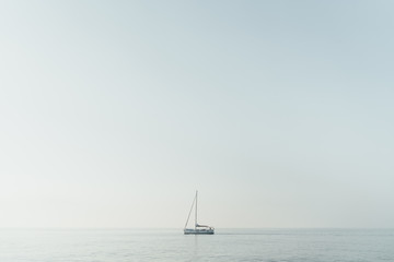 One lonely yacht in a blue sea horizontal panoramic