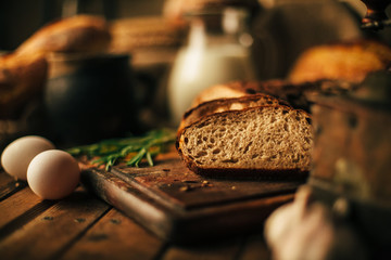 Still life. Agricultural products: eggs, milk, fresh bread on a wooden table. Close-up One trick