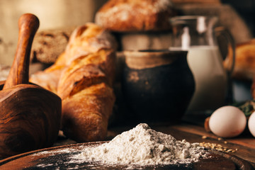 Still life. Agricultural products: eggs, milk, fresh bread on a wooden table. Close-up One trick