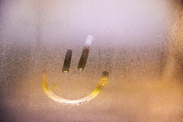 Foggy glass on window with drawn Smiley happy concept