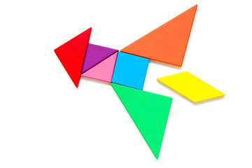 Color wood tangram puzzle in rocket shape on white background